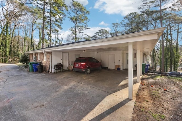 view of vehicle parking featuring an attached carport and concrete driveway