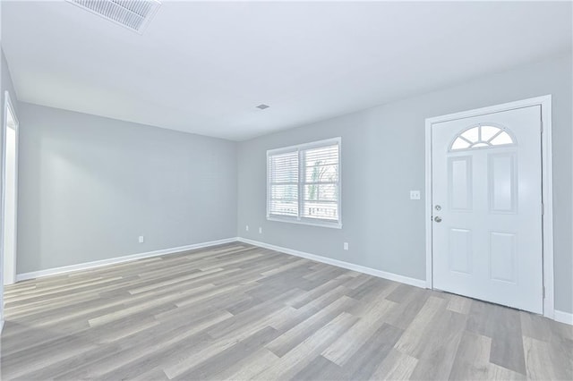 entrance foyer featuring visible vents, baseboards, and light wood-type flooring