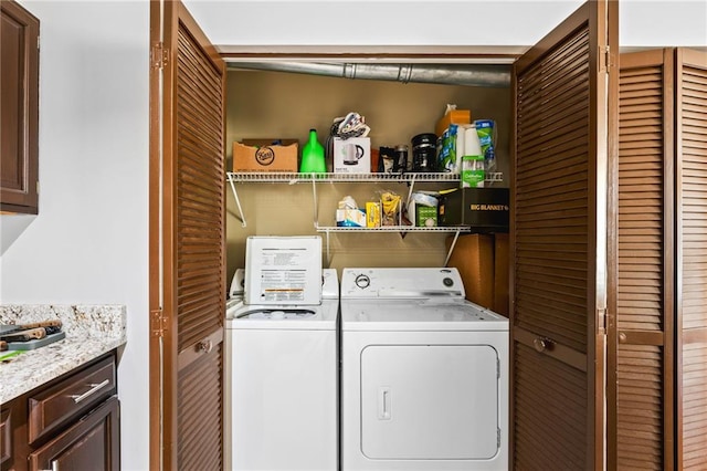 clothes washing area with independent washer and dryer and laundry area