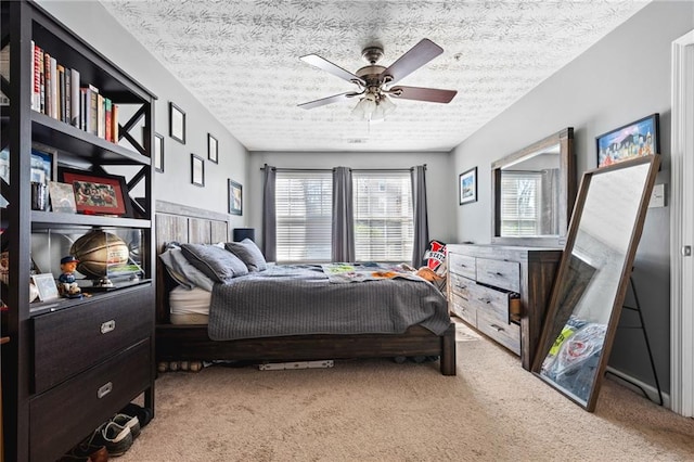 bedroom featuring multiple windows, light colored carpet, and a textured ceiling