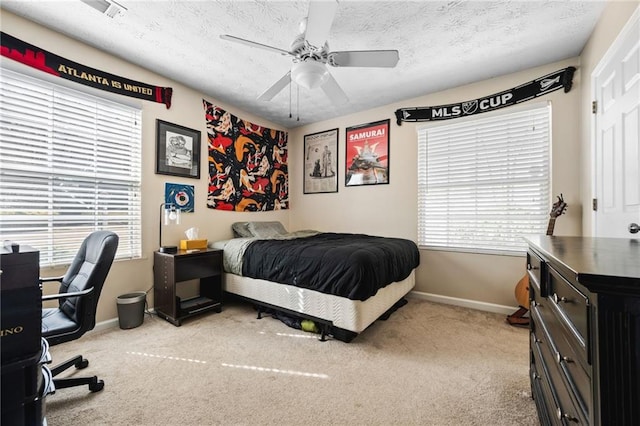 bedroom with baseboards, carpet, a ceiling fan, and a textured ceiling