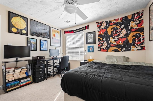 bedroom with visible vents, carpet, a ceiling fan, and a textured ceiling