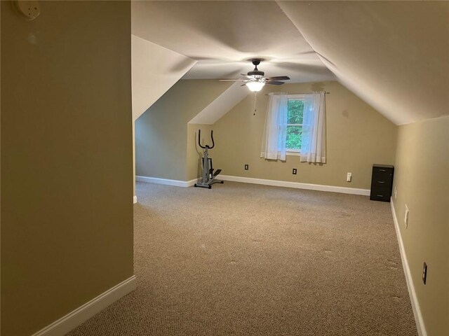 additional living space featuring light carpet, vaulted ceiling, and ceiling fan