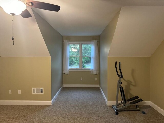 additional living space featuring vaulted ceiling, light carpet, and ceiling fan