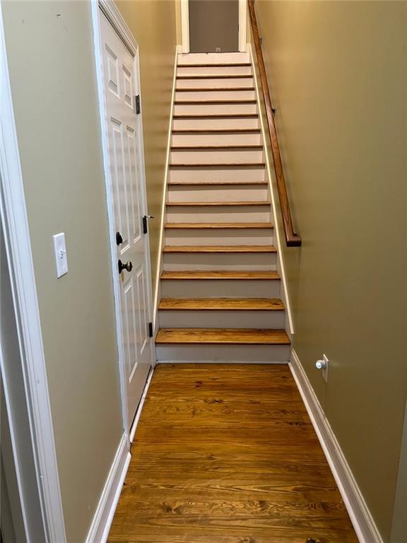 staircase featuring wood-type flooring