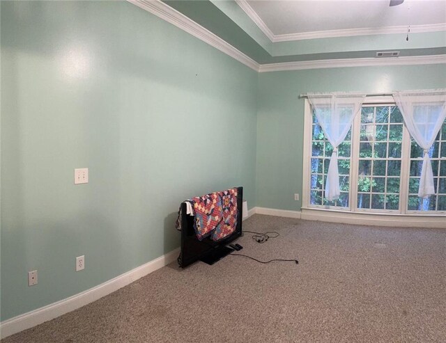 unfurnished room with crown molding, carpet flooring, and ceiling fan