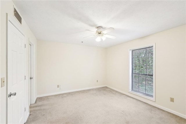 unfurnished room featuring light carpet and ceiling fan