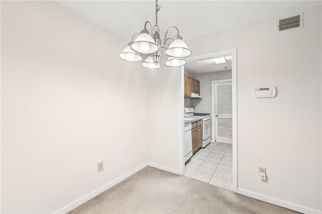 kitchen featuring pendant lighting, white appliances, light carpet, and a notable chandelier