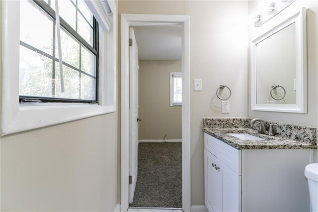 bathroom featuring vanity and toilet