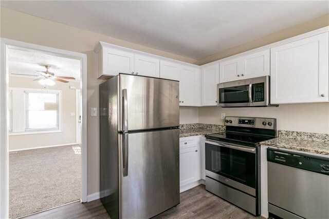 kitchen featuring white cabinets, appliances with stainless steel finishes, and light stone countertops