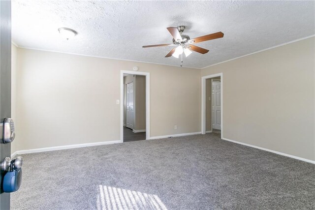 carpeted empty room featuring a textured ceiling and ceiling fan
