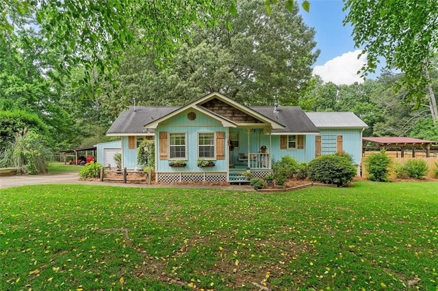 8669 Davis St, Braselton, GA 30517 - view of front of house featuring a porch, concrete driveway, a front lawn, a carport, and a garage
