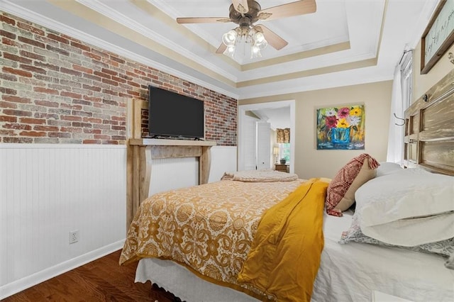 8669 Davis St, Braselton, GA 30517 - bedroom with a tray ceiling, wood finished floors, crown molding, brick wall, and a ceiling fan
