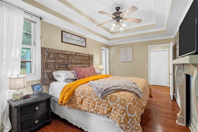 8669 Davis St, Braselton, GA 30517 - bedroom featuring a raised ceiling, wood finished floors, ornamental molding, a premium fireplace, and ceiling fan