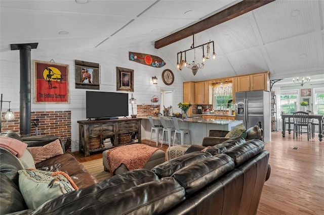 8669 Davis St, Braselton, GA 30517 - living area featuring a chandelier, wood finished floors, and a wood stove