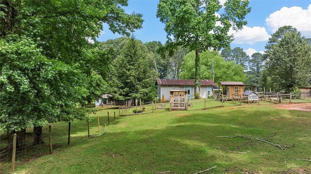 8669 Davis St, Braselton, GA 30517 - view of yard with an outbuilding, exterior structure, and a vegetable garden