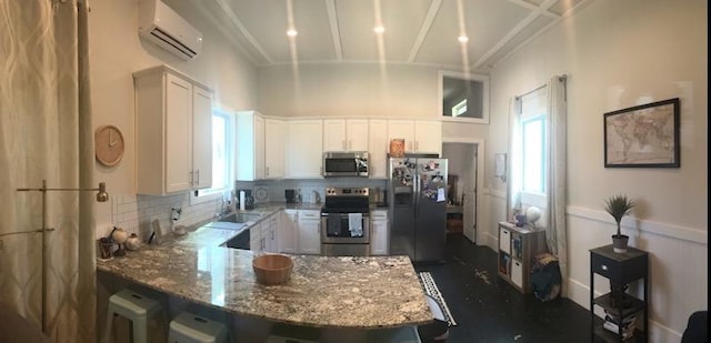 8669 Davis St, Braselton, GA 30517 - kitchen with stainless steel appliances, an AC wall unit, light stone countertops, backsplash, and white cabinets