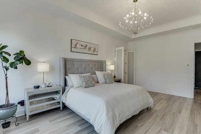 bedroom with light wood-type flooring and a notable chandelier