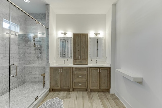 bathroom featuring vanity, an enclosed shower, and wood-type flooring