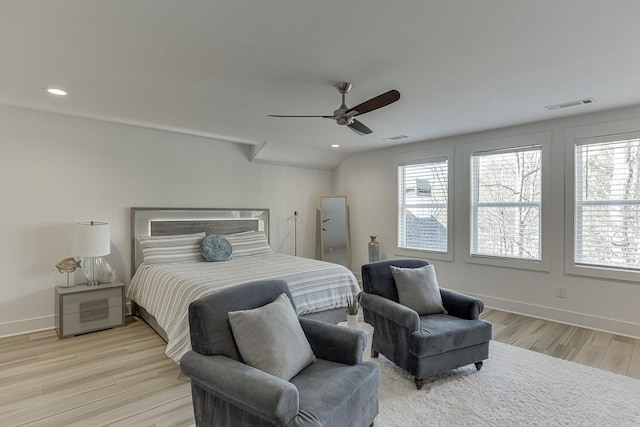 bedroom with ceiling fan, light hardwood / wood-style floors, and multiple windows