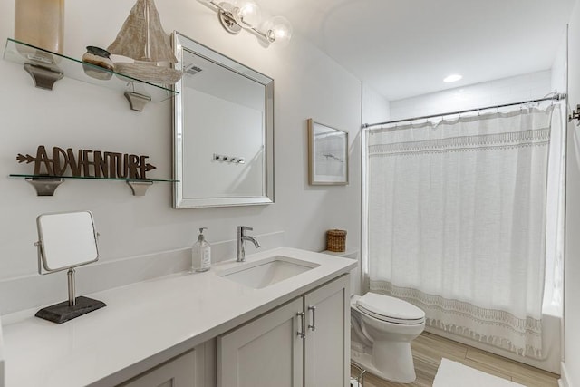 full bathroom with vanity, toilet, shower / tub combo, and hardwood / wood-style floors