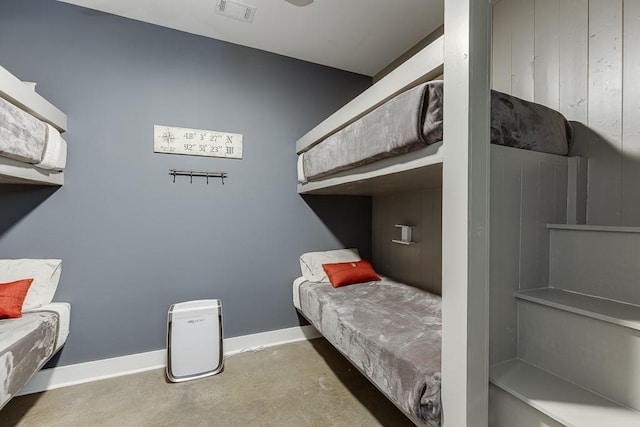 bedroom featuring concrete flooring