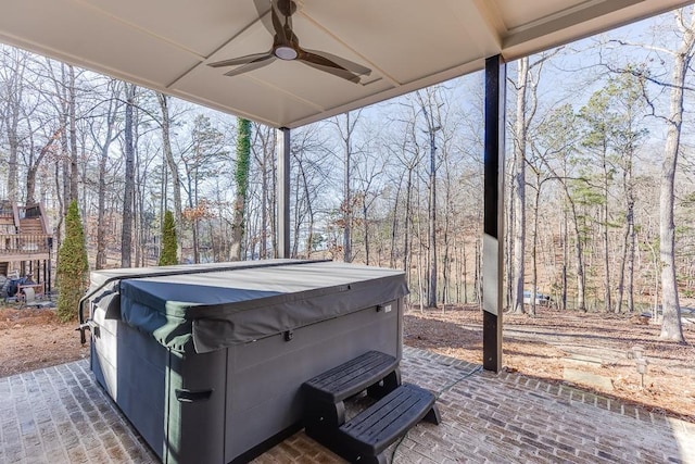 view of patio with ceiling fan and a hot tub