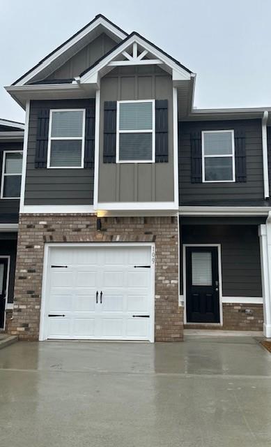 view of front facade with concrete driveway and brick siding