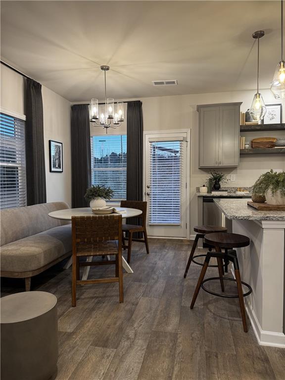 living room featuring dark wood-type flooring and ceiling fan with notable chandelier