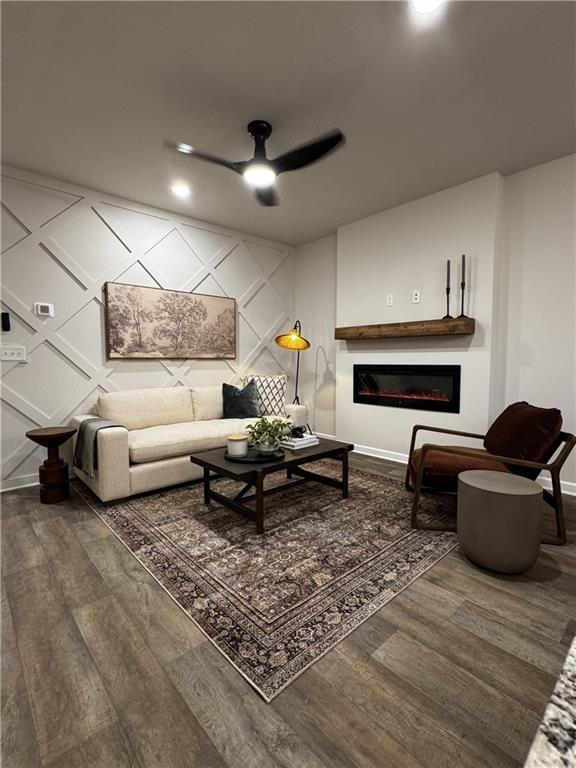 living room with ceiling fan and wood-type flooring