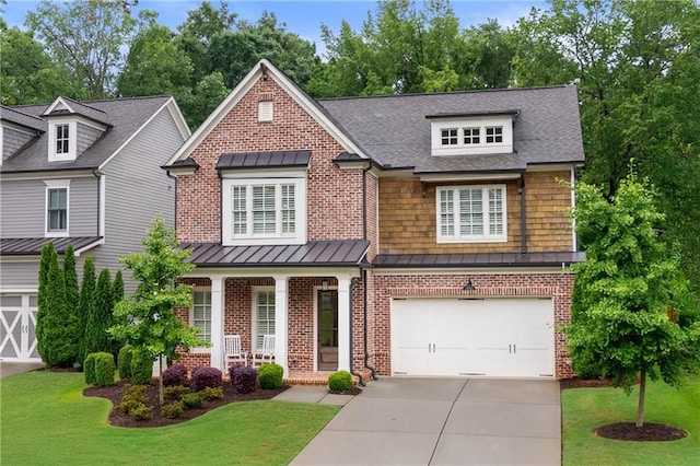 281 Green Hill Rd, Atlanta, GA 30342 - view of front facade with driveway, brick siding, a standing seam roof, a front lawn, and covered porch