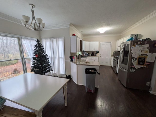 405 Baneberry Bnd, Peachtree City, GA 30269 - kitchen with white cabinetry, crown molding, dark hardwood / wood-style flooring, pendant lighting, and stainless steel appliances