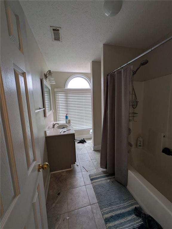 405 Baneberry Bnd, Peachtree City, GA 30269 - bathroom featuring vanity, shower / tub combo, tile patterned floors, and a textured ceiling