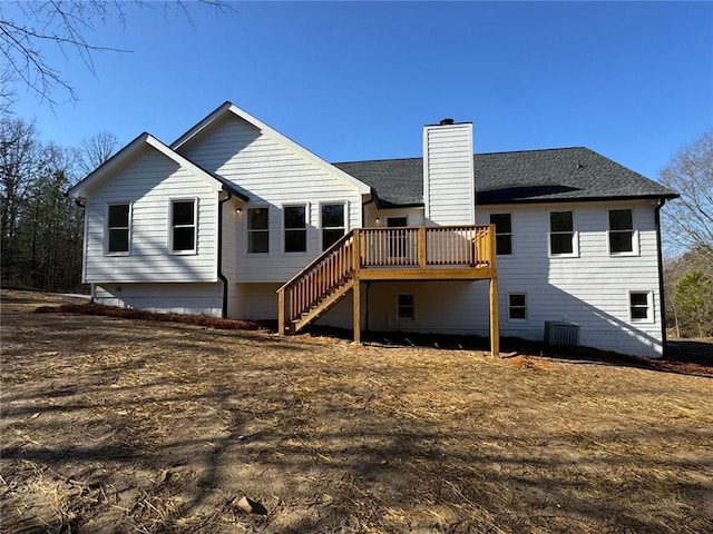 rear view of house featuring a wooden deck and central air condition unit