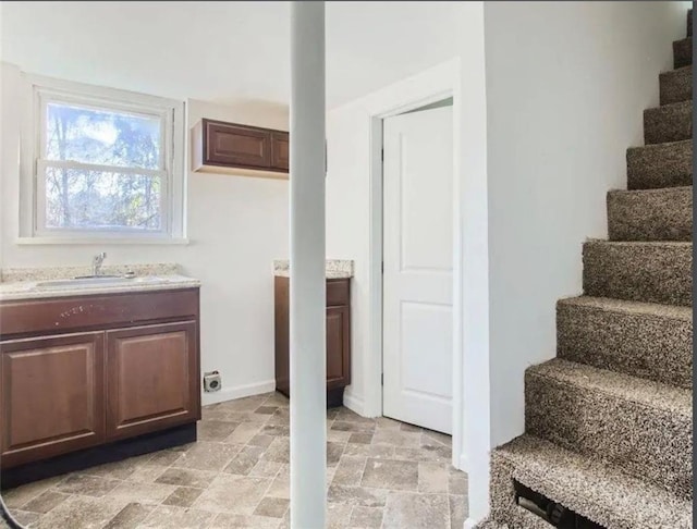 stairway with baseboards and stone finish flooring