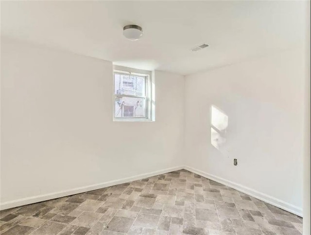 empty room featuring visible vents and baseboards