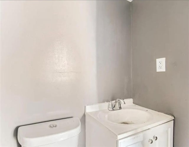 bathroom featuring toilet and vanity