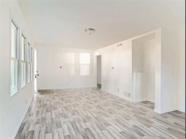 unfurnished room with light wood finished floors