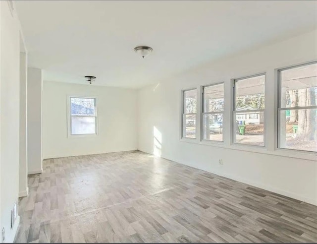 spare room with wood finished floors