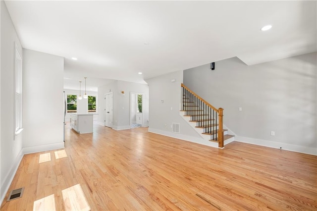 unfurnished living room with light hardwood / wood-style flooring