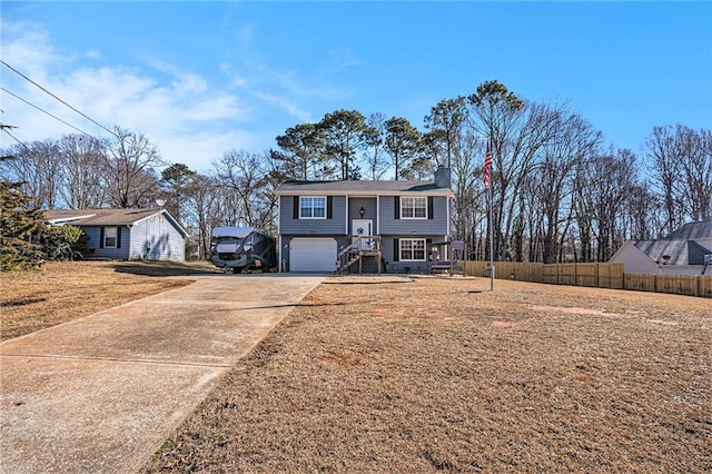 bi-level home featuring a garage and a front yard