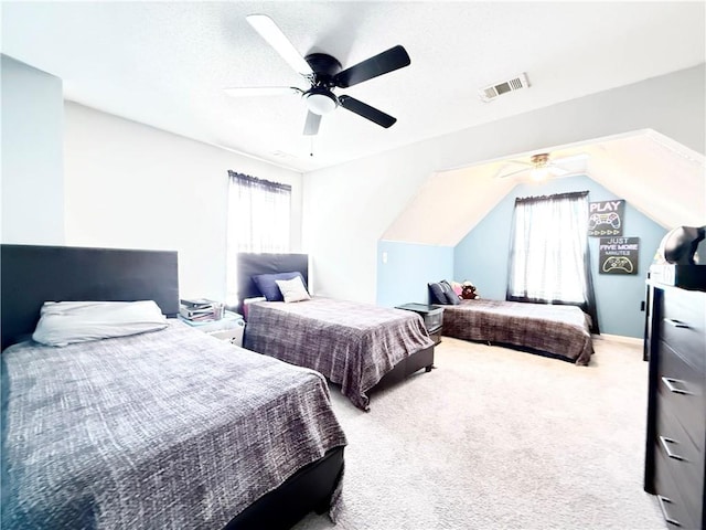 carpeted bedroom featuring lofted ceiling, visible vents, and ceiling fan