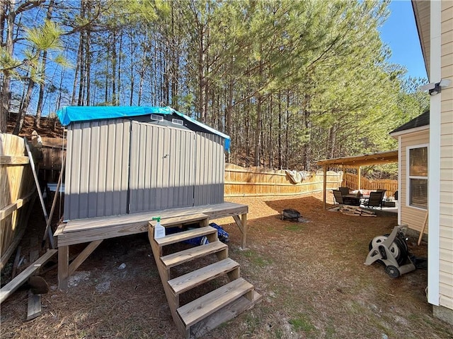 view of yard with a fenced backyard, an outdoor structure, and a shed