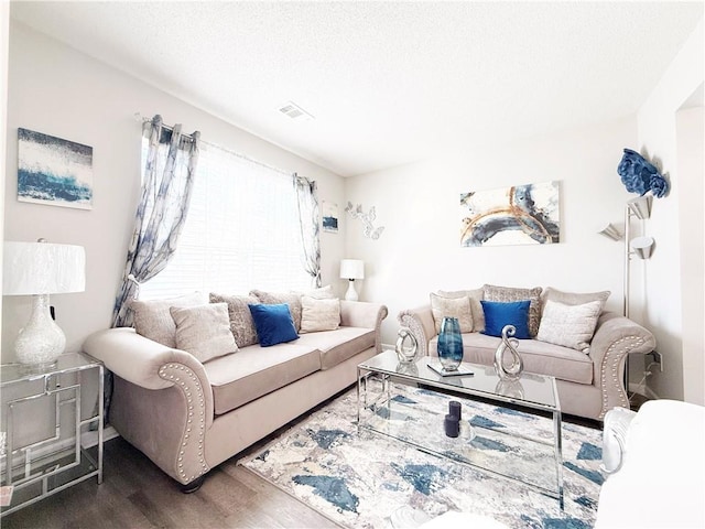 living room with wood finished floors and visible vents