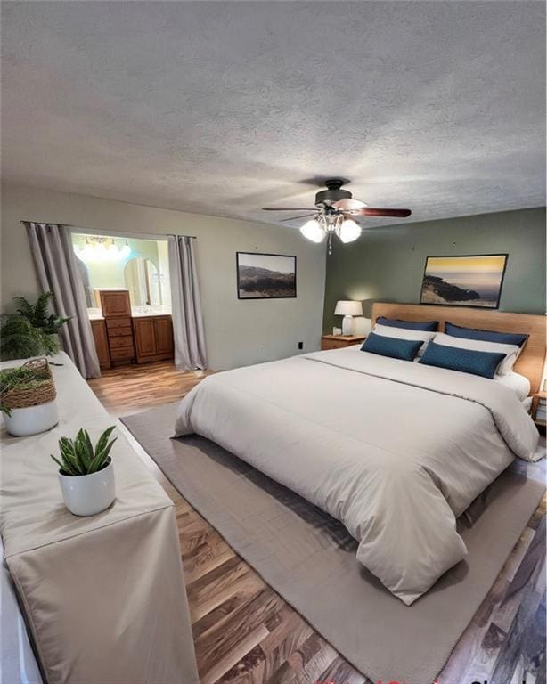 bedroom with a textured ceiling, ceiling fan, and hardwood / wood-style floors