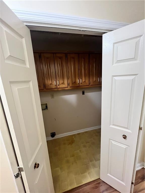 laundry room featuring hookup for a washing machine, cabinets, and electric dryer hookup