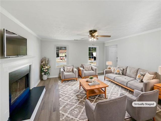 living room featuring ceiling fan, wood-type flooring, and crown molding