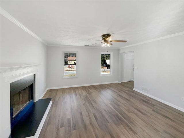 unfurnished living room featuring hardwood / wood-style floors, ceiling fan, and ornamental molding