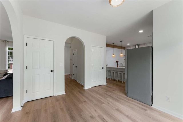 3285 Country Walk Dr, Powder Springs, GA 30127 - spare room featuring arched walkways, light wood finished floors, baseboards, and recessed lighting