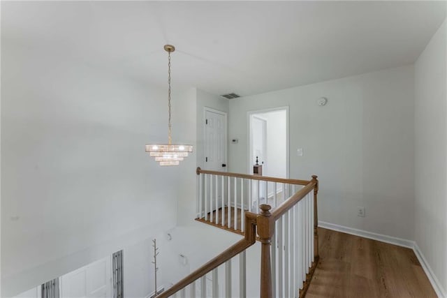 3285 Country Walk Dr, Powder Springs, GA 30127 - hall with an upstairs landing, a chandelier, wood finished floors, and baseboards